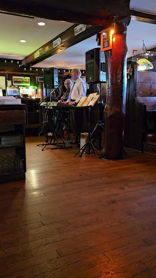 Pub interior with casual seating and dark wood finishes.