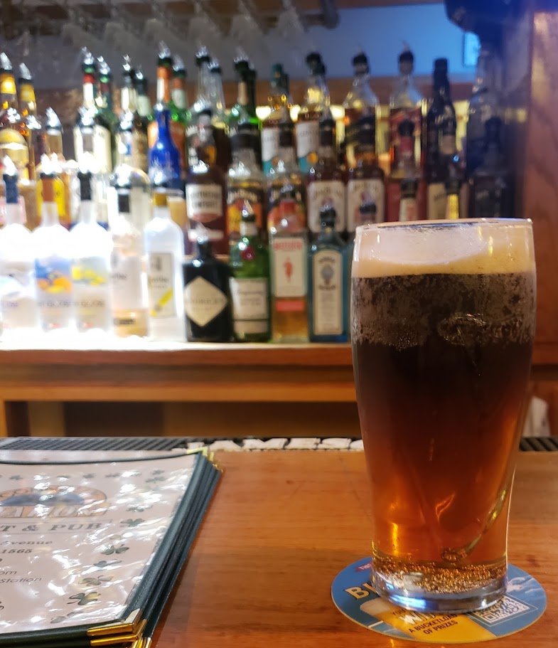 Pub interior with casual seating and dark wood finishes.